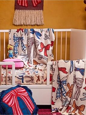 Sage and Clare. Bow Pattern Cot Blanket - Beige with Multi-Colored Bows. Cotton.